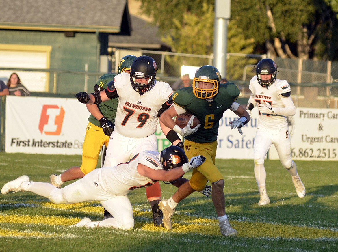 Senior Bulldog Jack Eisenbarth looks to make a path while surrounded by the Frenchtown defense Friday evening at Memorial Field. (Heidi Desch/Whitefish Pilot)