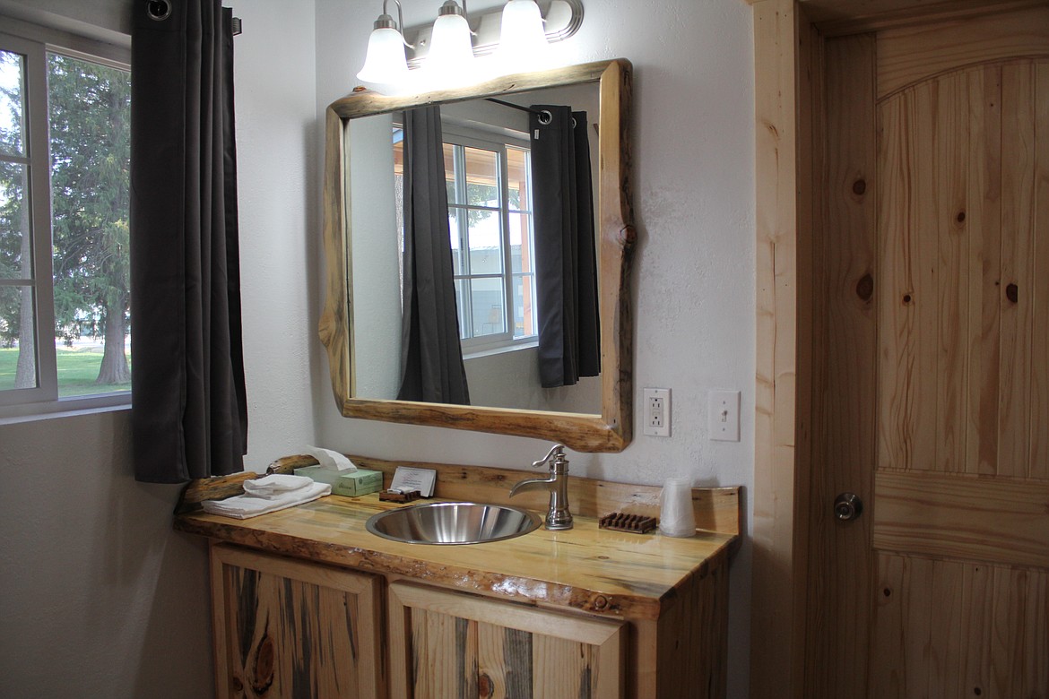 The new wash basin vanity in the most recently updated room sports a rustic design which flourishes throughout the room.