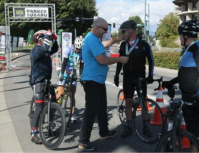 DEVIN WEEKS/Press file
Coeur d&#146;Fondo race director Isaac Mann congratulates Stephen Ayers of Coeur d&#146;Alene at the finish line after he completes the Medio Fondo race during the 2017 event. The seventh annual Coeur d&#146;Fondo is Saturday and will feature international professional cyclists from Italy as well as participants from Canada and around the U.S.