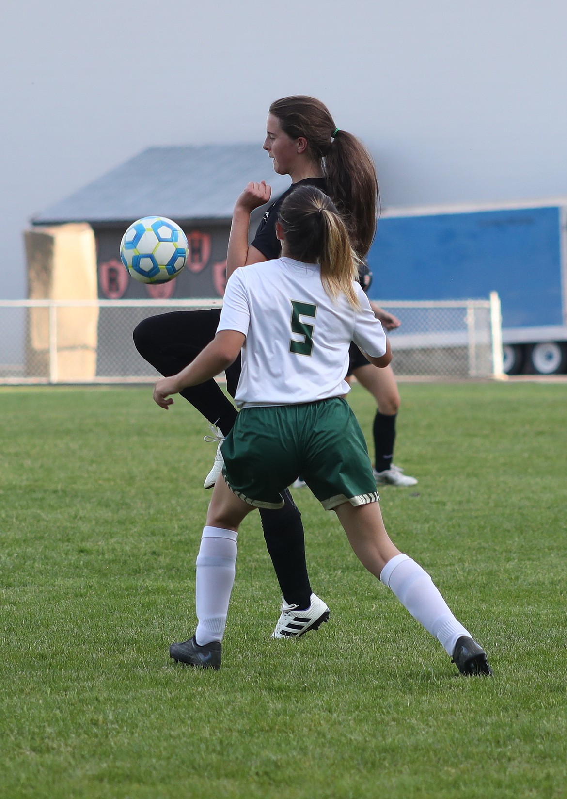 (Photo by ERIC PLUMMER)
Freshman Ainslee Nordsby knees a ball earlier in the season for the Spartans, who fell to the Tigers recently in IML play.