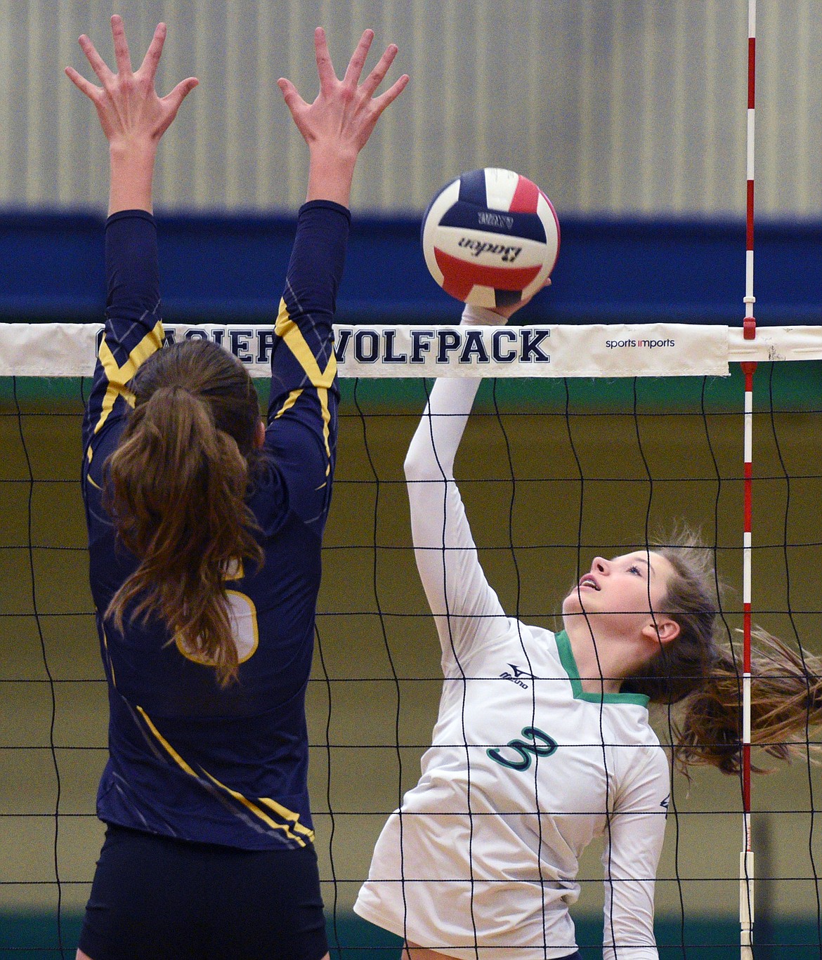 Glacier&#146;s Sidney Gulick (3) goes for a kill against Missoula Big Sky&#146;s Katie Rolle (5) at Glacier High School on Saturday. (Casey Kreider/Daily Inter Lake)