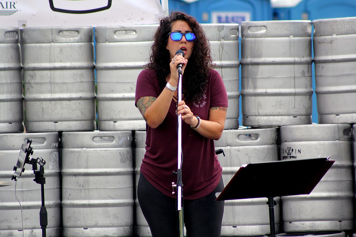 Richard Byrd/Columbia Basin Herald
Singer Jamie Nasario, with a wall of beer kegs at her back, hits a high note during Craft Out Cancer on Saturday.