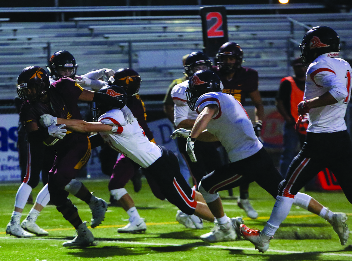 Connor Vanderweyst/Columbia Basin Herald
Chiefs running back Moses Garza (left) carries defenders into the end zone for a touchdown.