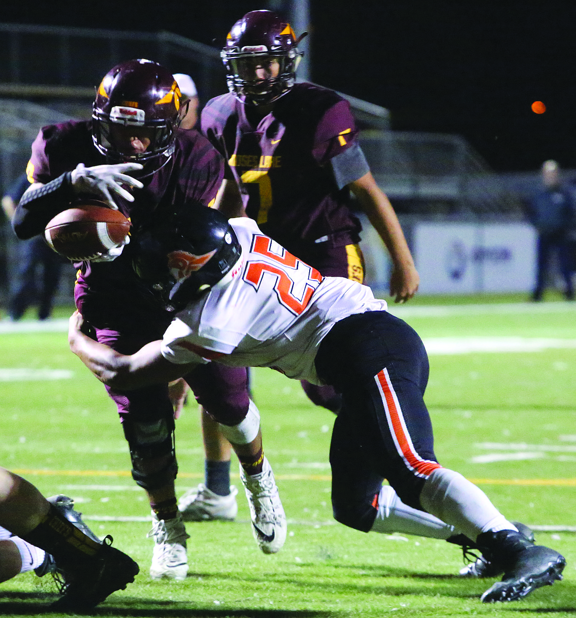 Connor Vanderweyst/Columbia Basin Herald
Post Falls linebacker Eli Gondo (25) forces Moses Lake running back Moses Garza to fumble.