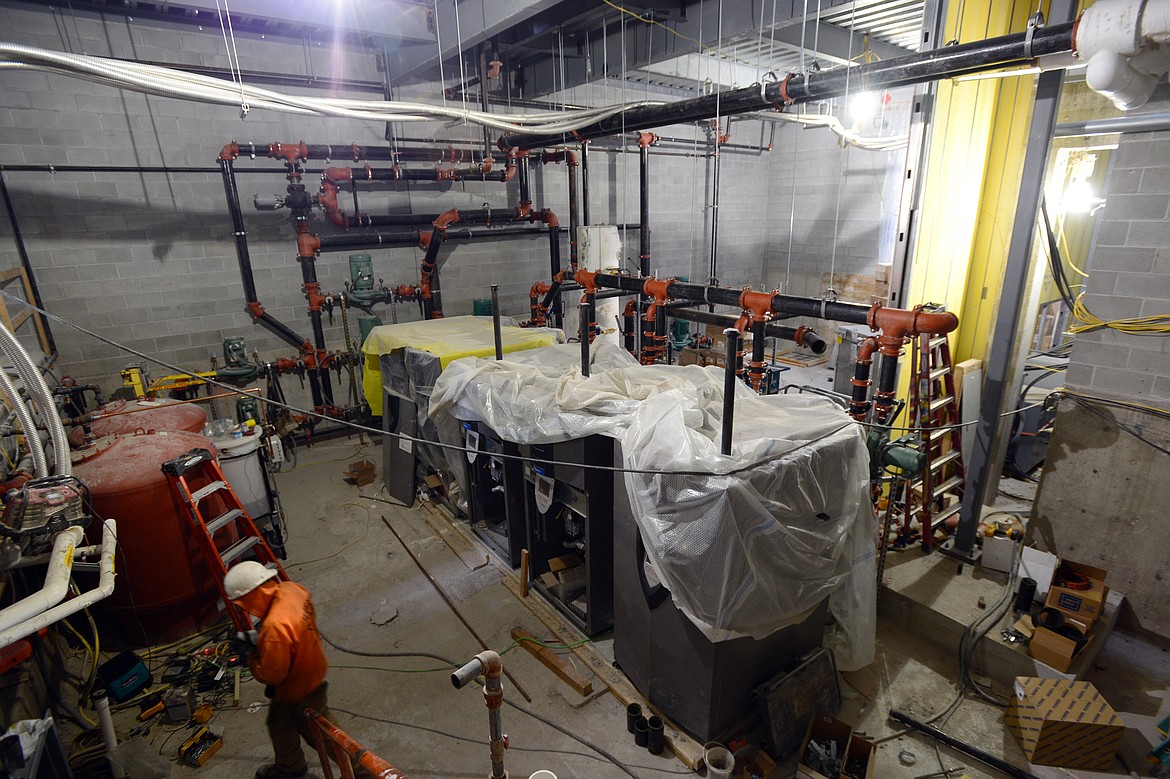 A worker walks through the new mechanical room under construction at Flathead High School on Wednesday. (Casey Kreider/Daily Inter Lake)