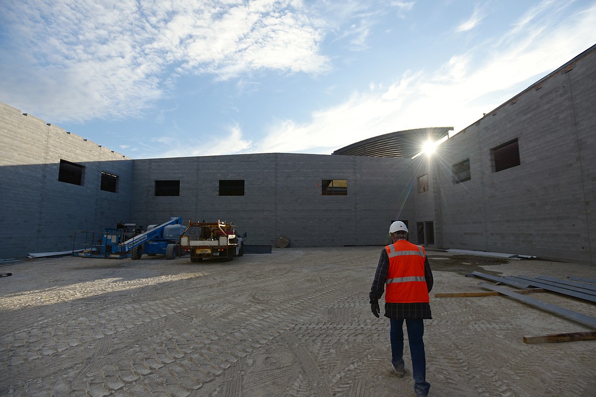 Stan DeBlauw, site superintendent with Swank Enterprises, walks through an area that will become the new gymasium at Flathead High School on Wednesday. (Casey Kreider/Daily Inter Lake)