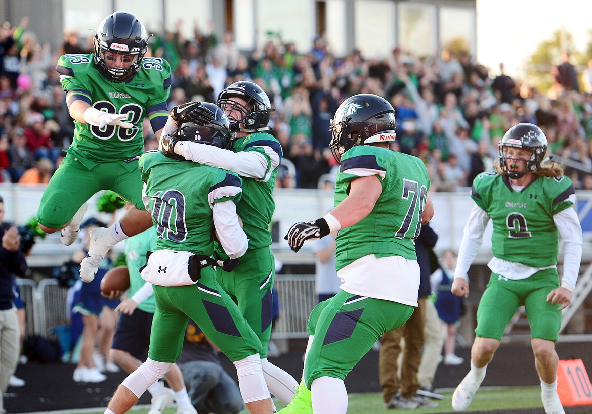 From left, Glacier's Preston Blain (33), Travis Proulx (10), Colin Bowden (1), Larrison Stevens (76) and Evan Todd (2) celebrate after Proulx's first-quarter touchdown reception against Helena at Legends Stadium on Friday. (Casey Kreider/Daily Inter Lake)