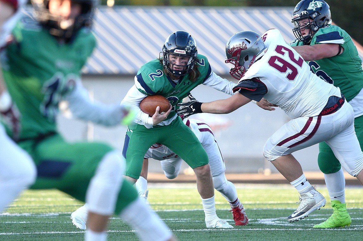 Glacier quarterback Evan Todd (2) looks for room to run in the first quarter against Helena at Legends Stadium on Friday. (Casey Kreider/Daily Inter Lake)