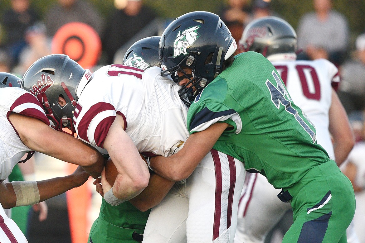 Glacier defensive back Gator Mostek (11) wraps up Helena quarterback Ty McGurran on fourth down in the second quarter at Legends Stadium on Friday. (Casey Kreider/Daily Inter Lake)