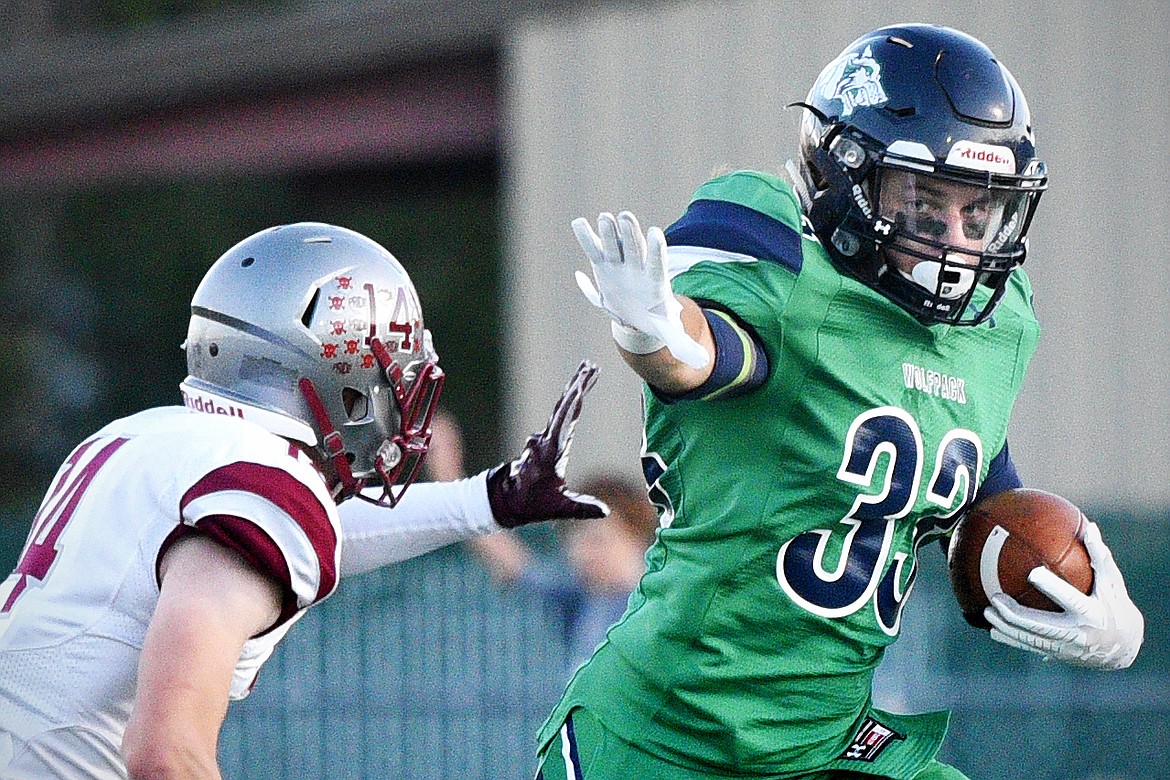 Glacier running back Preston Blain extends a stiff-arm to Helena defender Zachary Spiroff (14) on a second quarter run at Legends Stadium on Friday. (Casey Kreider/Daily Inter Lake)