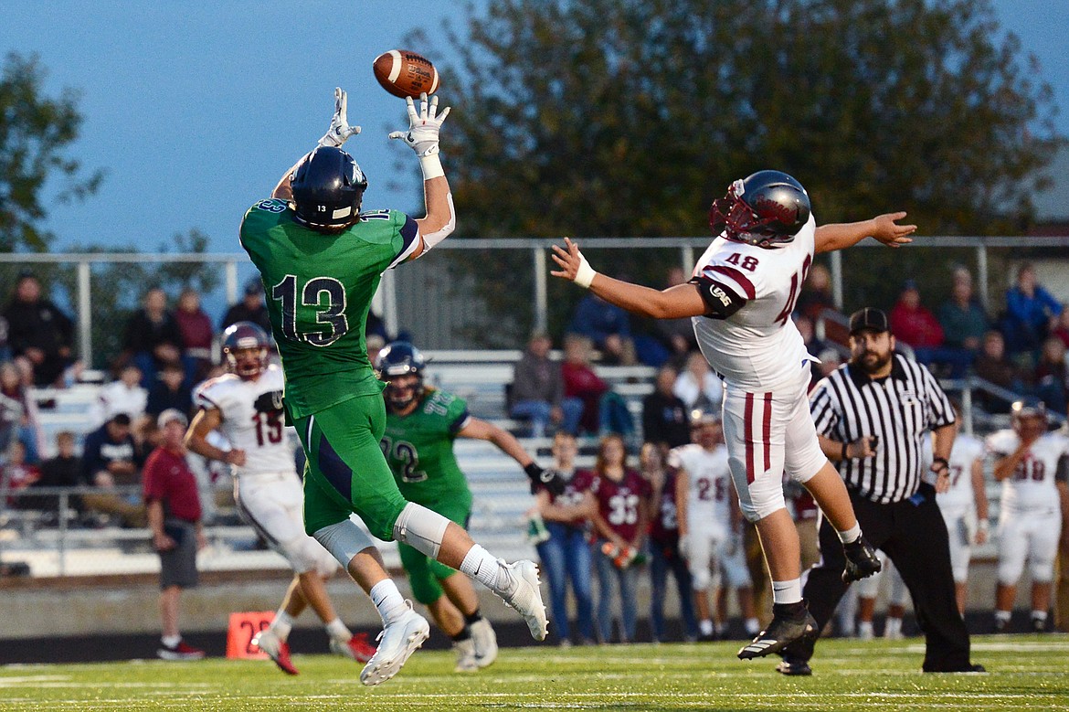 Glacier tight end Cole Crosby (13) hauls in a touchdown reception over Helena linebacker Zachary Evans (48) in the second quarter at Legends Stadium on Friday. (Casey Kreider/Daily Inter Lake)