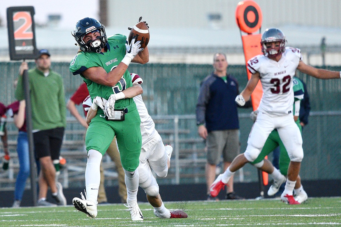 Glacier wide receiver Danny Anderson hangs on to a reception in the second quarter against Helena at Legends Stadium on Friday. (Casey Kreider/Daily Inter Lake)