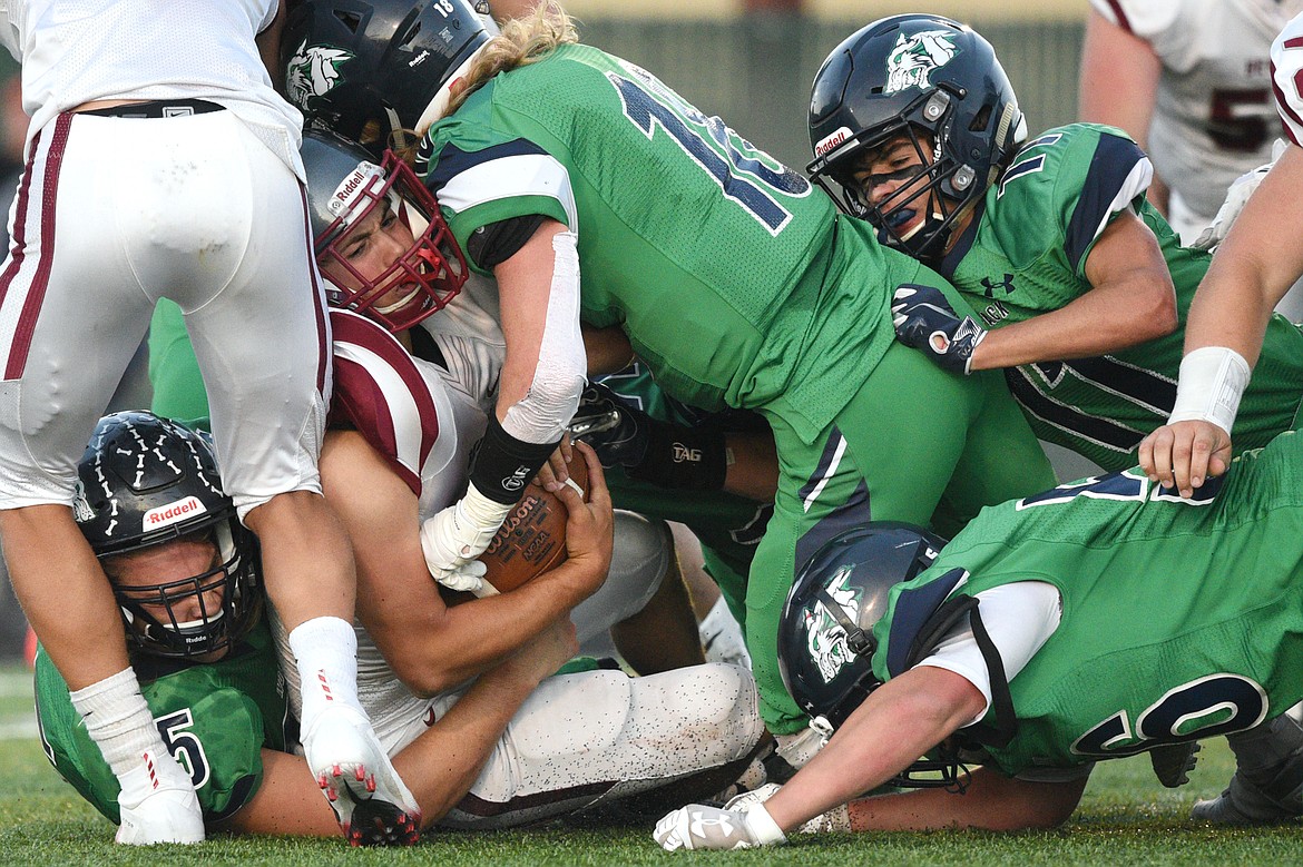 Helena running back Grady Koenig (34) is stopped by a host of Glacier defenders in the second quarter at Legends Stadium on Friday. (Casey Kreider/Daily Inter Lake)