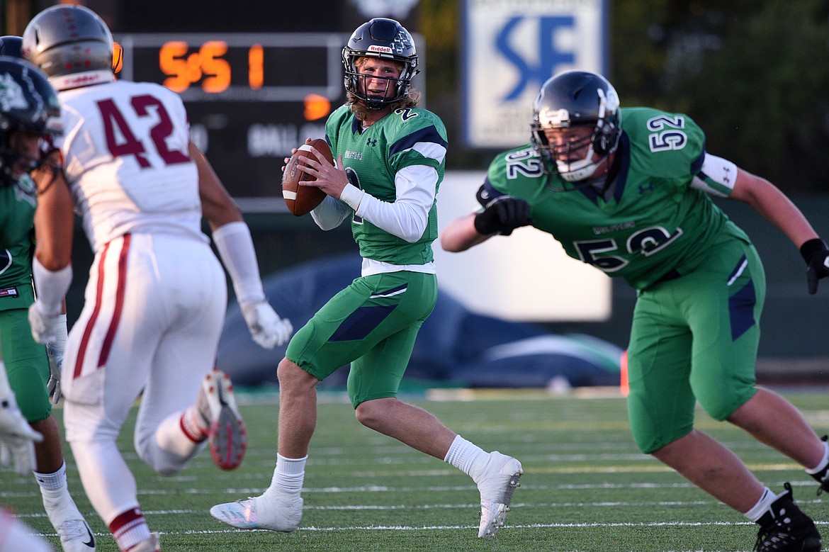 Glacier quarterback Evan Todd rolls out and finds wide receiver Travis Proulx (10) for a touchdown reception in the first quarter against Helena at Legends Stadium on Friday. (Casey Kreider/Daily Inter Lake)