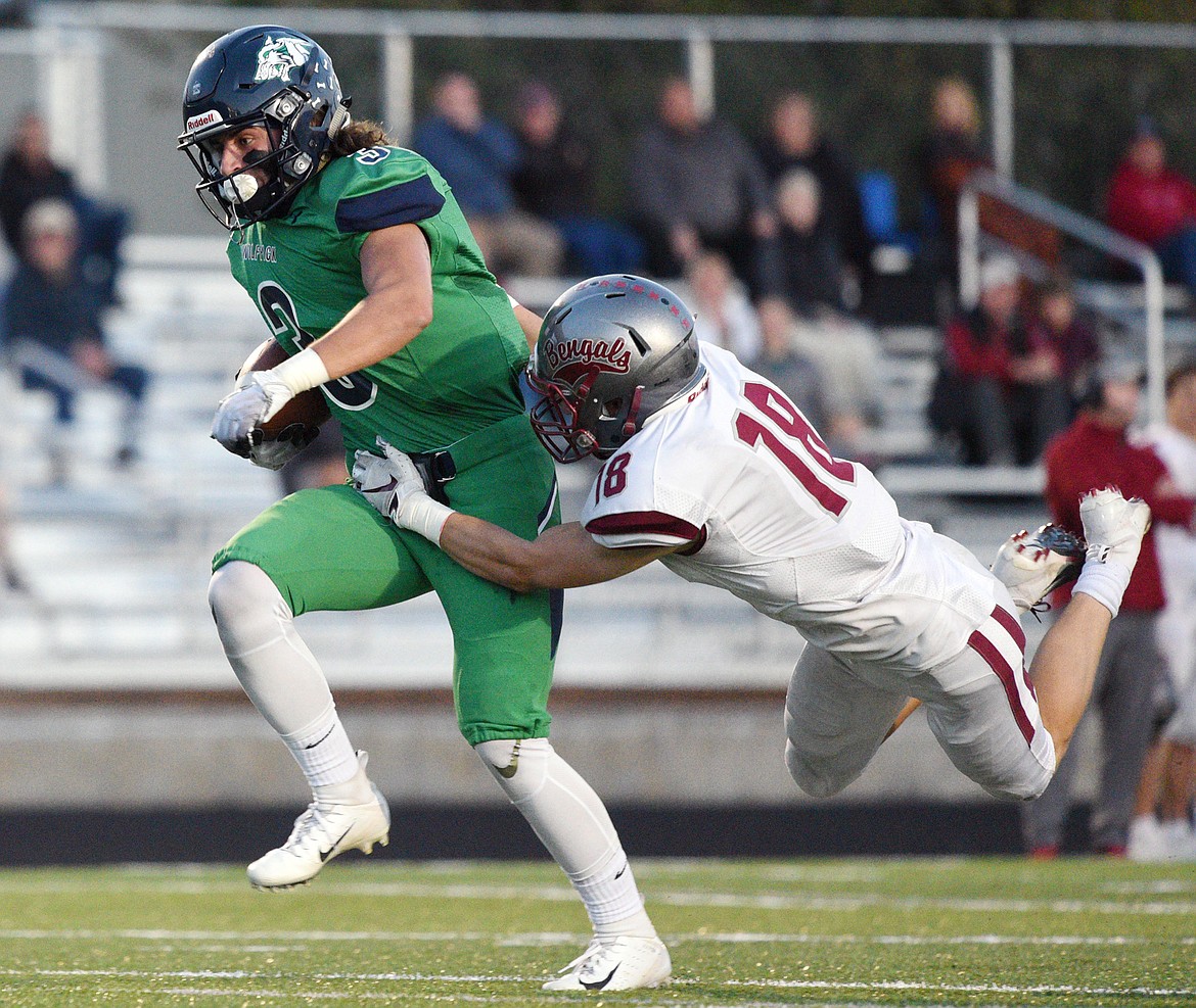 Glacier wide receiver Danny Anderson (3) sheds a tackle by Helena&#146;s Cooper Biegler (18) on a long touchdown reception in the second quarter at Legends Stadium on Friday. (Casey Kreider/Daily Inter Lake)