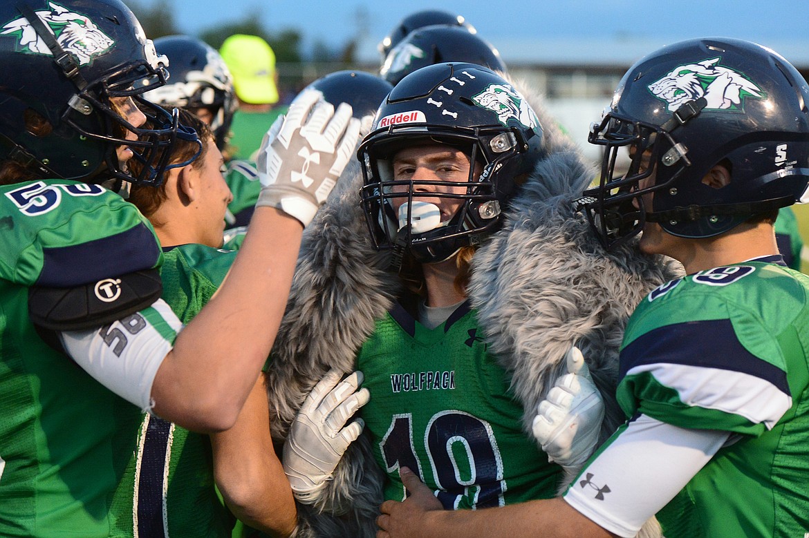 Glacier&#146;s Garret Frost (18) is wrapped in a fur after a big defensive play in the second quarter against Helena at Legends Stadium on Friday. (Casey Kreider/Daily Inter Lake)