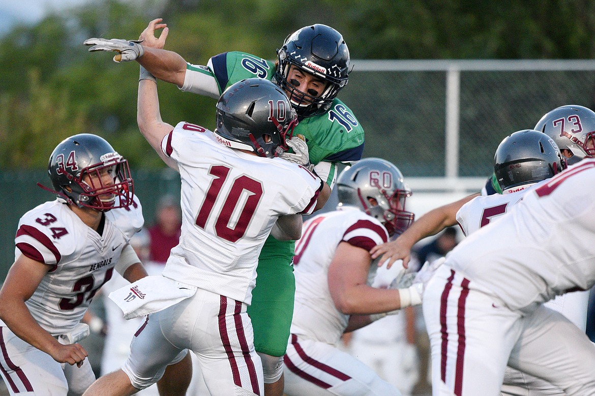 Glacier linebacker Clark Rianda (16) gets pressure on Helena quarterback Ty McGurran (10) in the second quarter at Legends Stadium on Friday. (Casey Kreider/Daily Inter Lake)