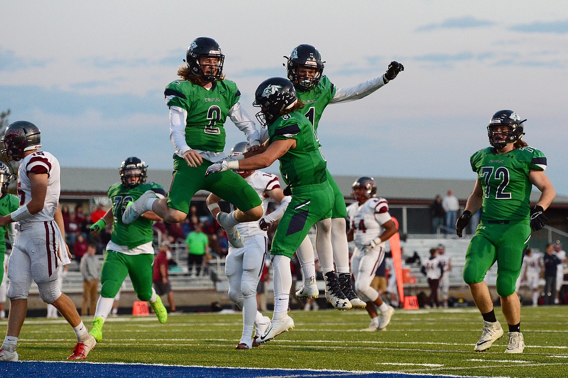 Glacier&#146;s Evan Todd (2), Danny Anderson (3) and Colin Bowden (1) celebrate after Anderson&#146;s long touchdown reception from Todd in the second quarter against Helena at Legends Stadium on Friday. (Casey Kreider/Daily Inter Lake)