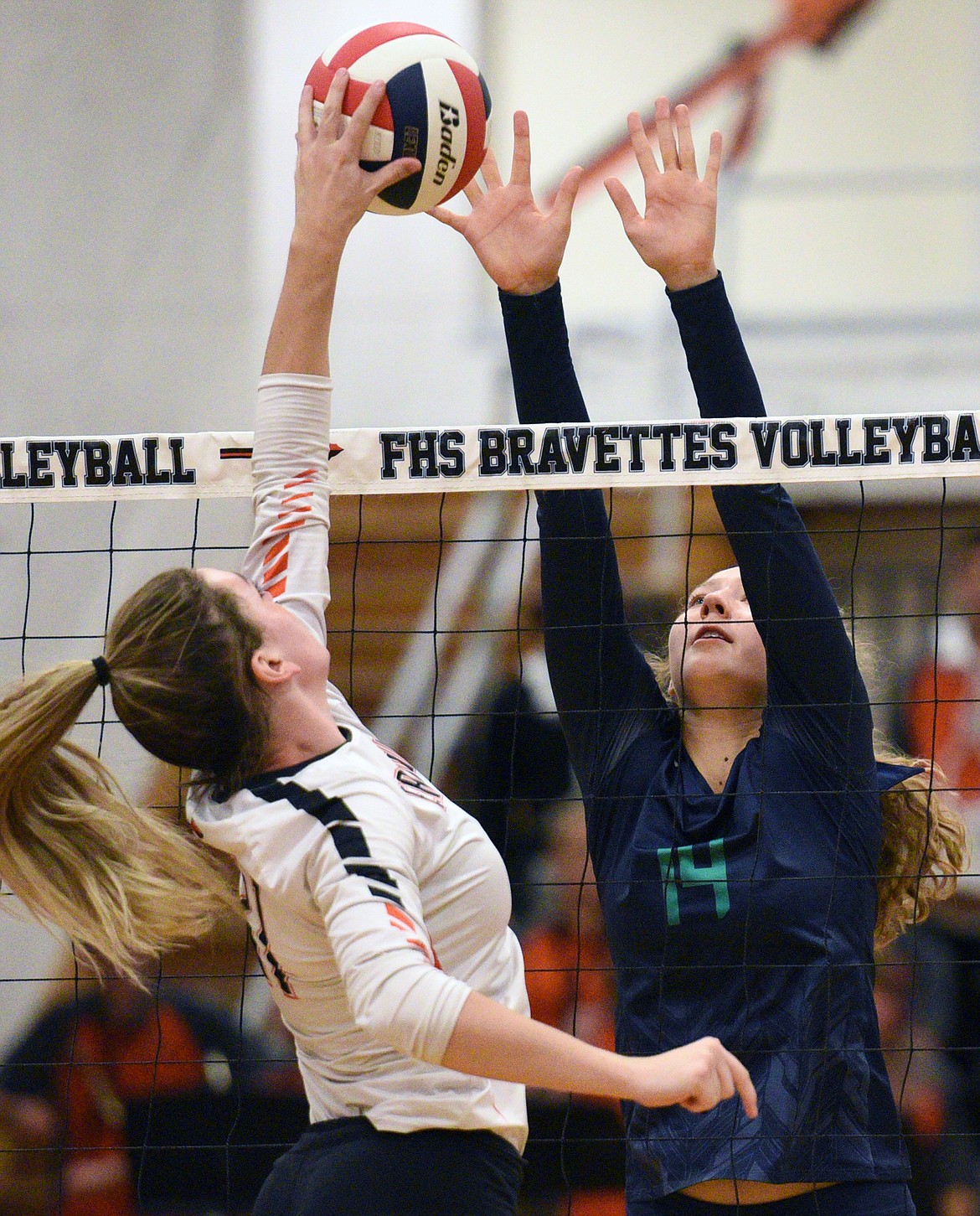 Flathead's Hannah O'Dell (11, left) and Glacier's Emma Anderson (14) meet at the net during crosstown volleyball at Flathead High School on Thursday. (Casey Kreider/Daily Inter Lake)