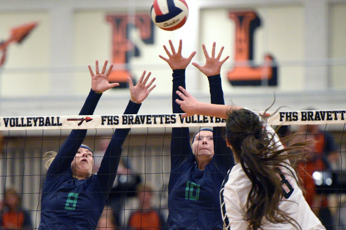 Glacier's Aubrie Rademacher (8) and Kynzie Mohl (10) attempt to block a kill by Flathead's Maddie Boles (18) during crosstown volleyball at Flathead High School on Thursday. (Casey Kreider/Daily Inter Lake)