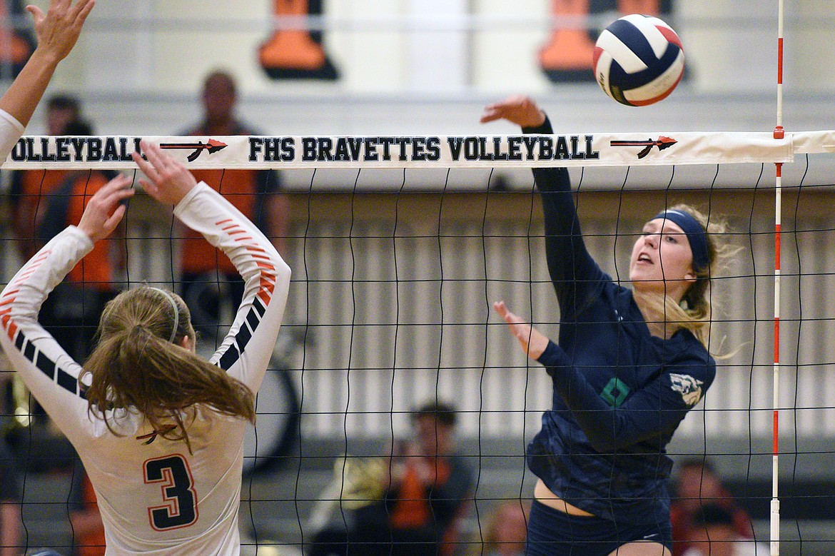 Glacier&#146;s Kali Gulick (9) goes for a kill against Flathead&#146;s Sierra Wilhelm (3) during crosstown volleyball at Flathead High School on Thursday. (Casey Kreider/Daily Inter Lake)