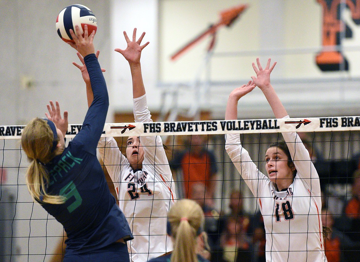 Glacier&#146;s Kali Gulick (9) tries for a kill as Flathead&#146;s Taylor Henley (24) and Maddie Boles (18) attempt to block during crosstown volleyball at Flathead High School on Thursday. (Casey Kreider/Daily Inter Lake)