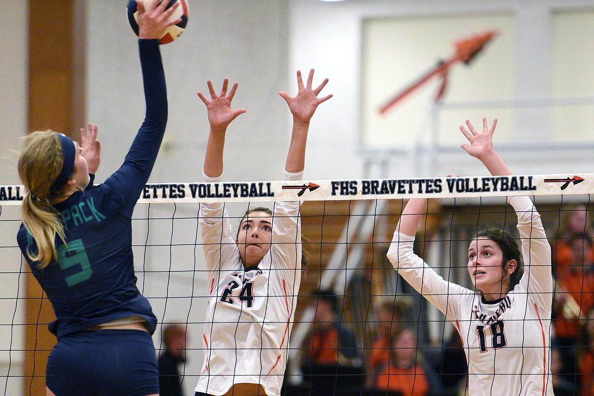 Glacier&#146;s Kali Gulick (9) tries for a kill as Flathead&#146;s Taylor Henley (24) and Maddie Boles (18) attempt to block during crosstown volleyball at Flathead High School on Thursday. (Casey Kreider/Daily Inter Lake)