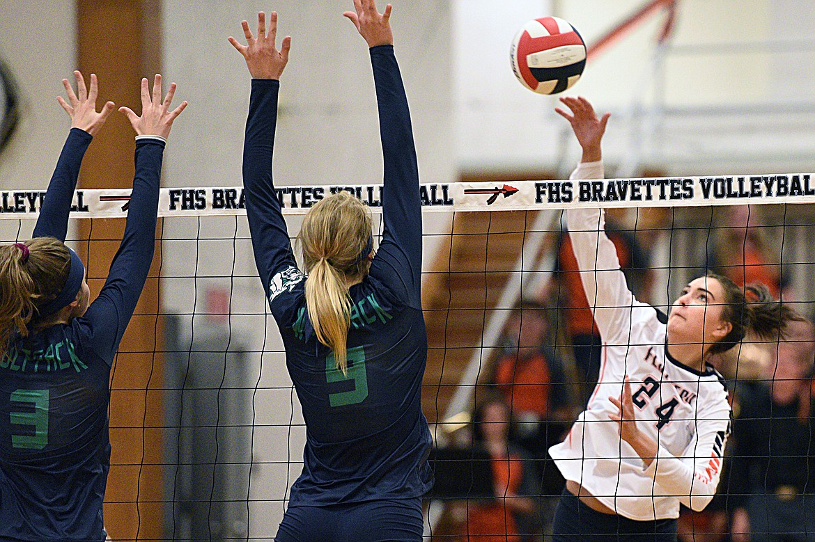 Flathead&#146;s Taylor Henley (24) goes for a kill with Glacier&#146;s Sidney Gulick (3) and Kali Gulick (9) defending during crosstown volleyball at Flathead High School on Thursday. (Casey Kreider/Daily Inter Lake)