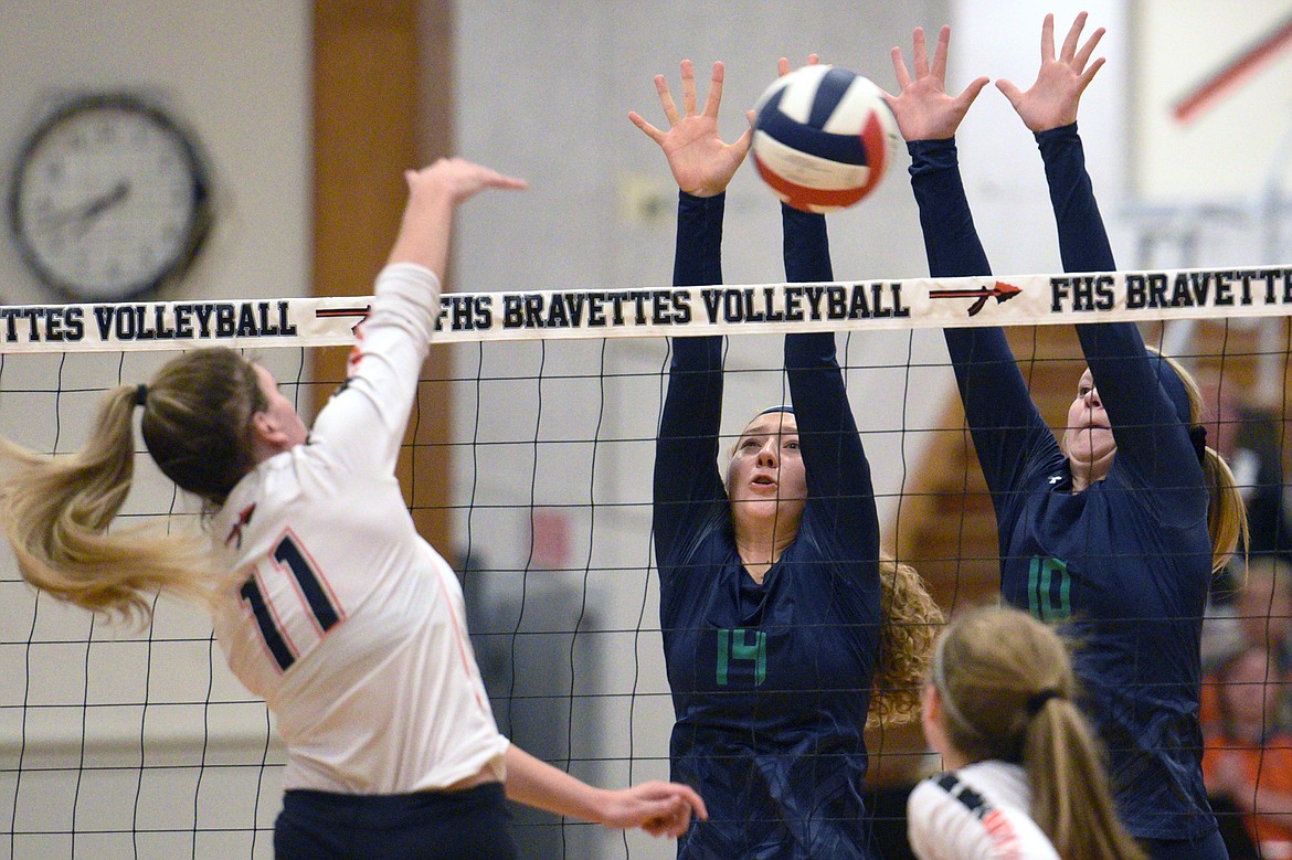 Flathead&#146;s Hannah O&#146;Dell goes for a kill as Glacier&#146;s Emma Anderson (14) and Kynzie Mohl (10) attempt a block during crosstown volleyball at Flathead High School on Thursday. (Casey Kreider/Daily Inter Lake)