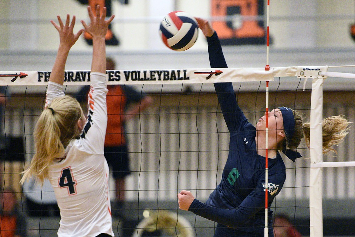 Glacier&#146;s Aubrie Rademacher (8) goes for a kill against Flathead&#146;s Jaylyn Fitch (4) during crosstown volleyball at Flathead High School on Thursday. (Casey Kreider/Daily Inter Lake)