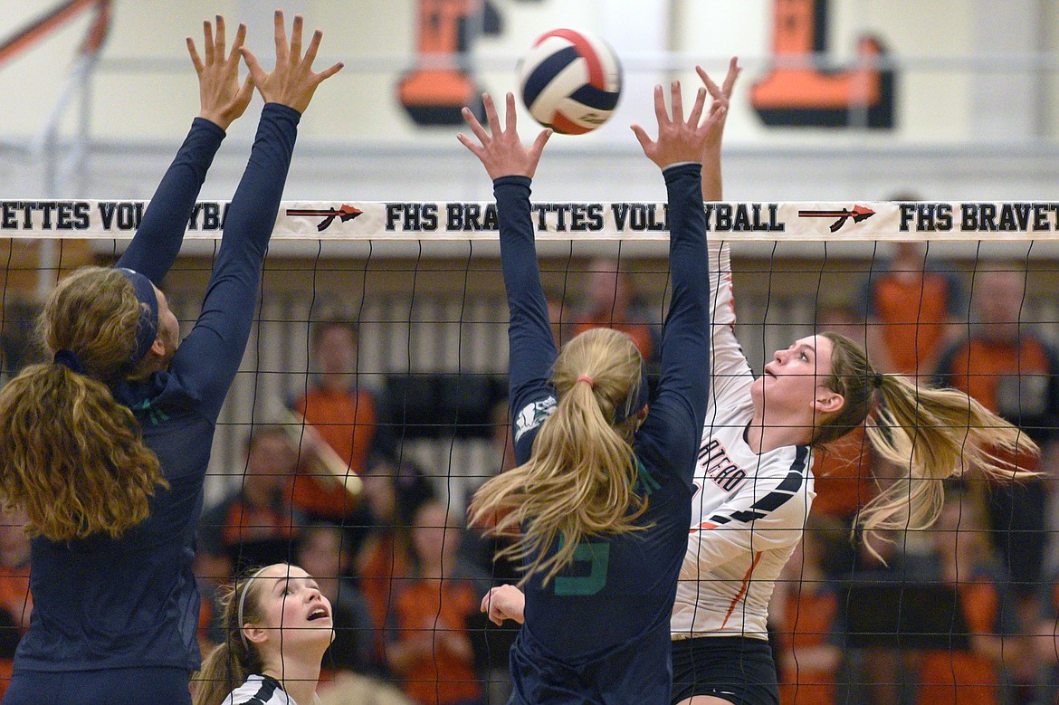 Flathead&#146;s Hannah O&#146;Dell (11) tries for a kill against the defense of Glacier&#146;s Emma Anderson (14, left) and Kaylee Fritz (5) during crosstown volleyball at Flathead High School on Thursday. (Casey Kreider/Daily Inter Lake)