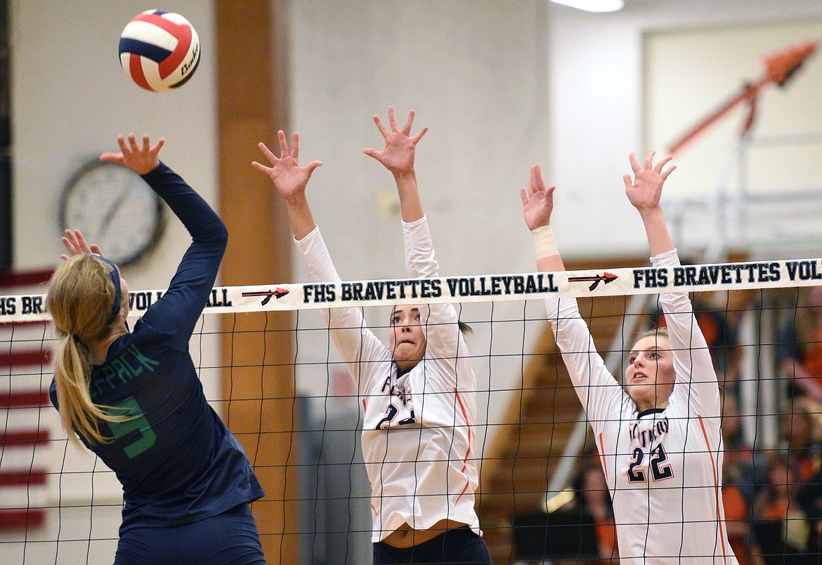 Glacier&#146;s Kali Gulick (9) tries for a kill as Flathead&#146;s Taylor Henley (24) and Julia Burden (22) attempt to block during crosstown volleyball at Flathead High School on Thursday. (Casey Kreider/Daily Inter Lake)