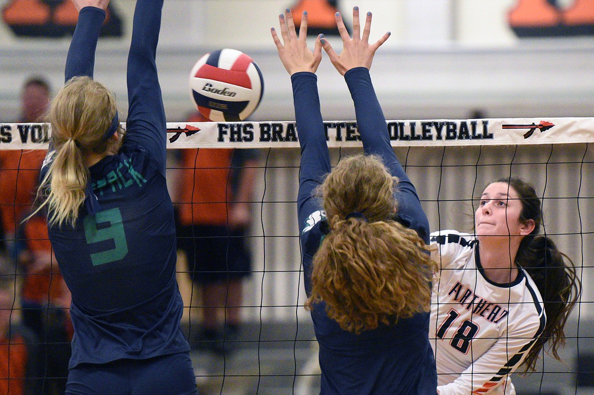 Flathead&#146;s Maddie Boles (18) goes up for a kill against Glacier&#146;s Kali Gulick (9) and Emma Anderson (14) during crosstown volleyball at Flathead High School on Thursday. (Casey Kreider/Daily Inter Lake)