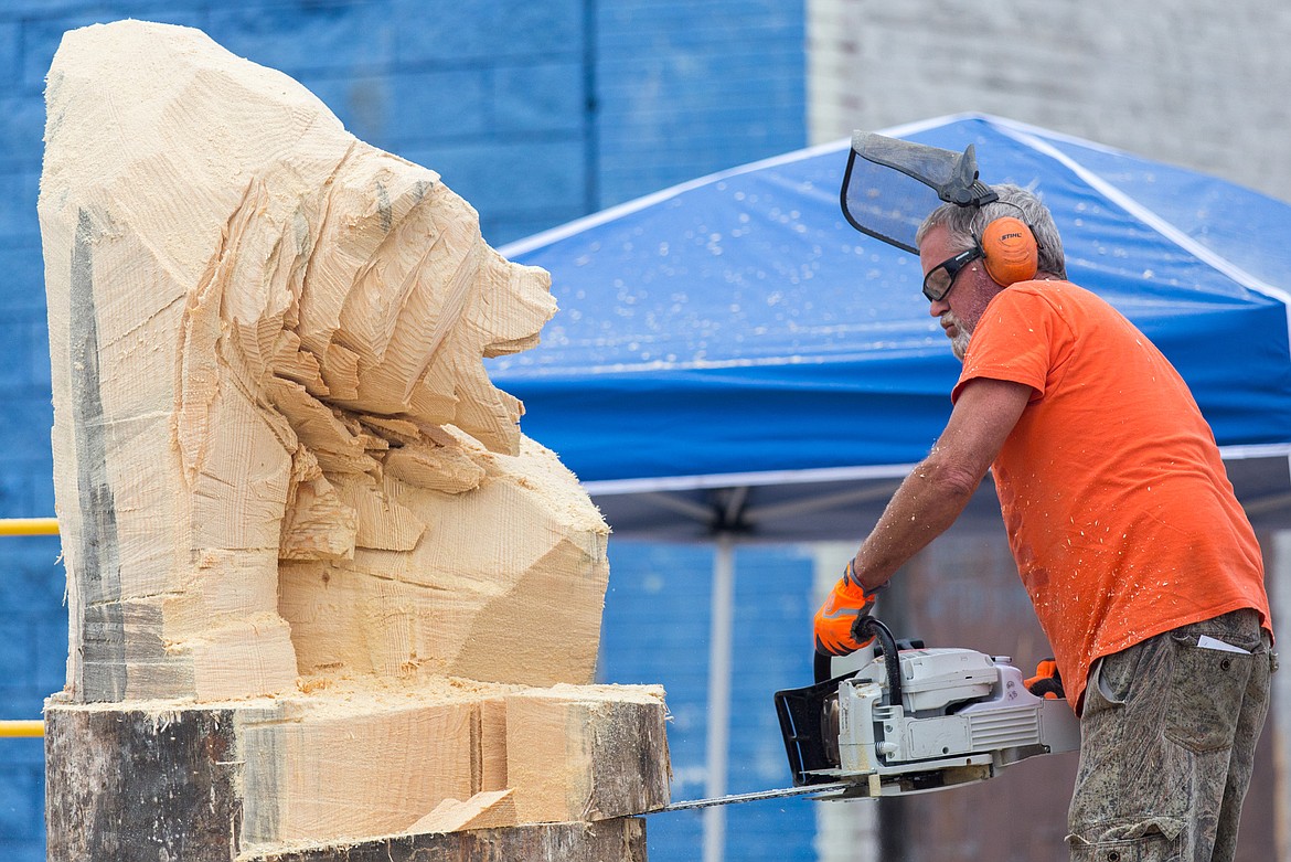 Todd Coats of Woods Bay carves a bear during the Kootenai Country Montana Chainsaw Carving Championship in Libby in 2017. (John Blodgett/The Western News file photo)