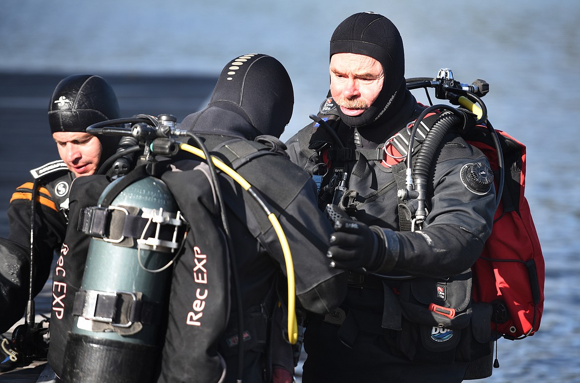 Flathead County Sheriff&#146;s Office Dive Team member Rich Schuster helps other divers with their gear before beginning a training exercise to prepare responders to deal with the potential discover of invasive aquatic species. While there are currently no invasive mussels in Flathead Lake, the potential does exist and must be prepared for.
(Brenda Ahearn/Daily Inter Lake)