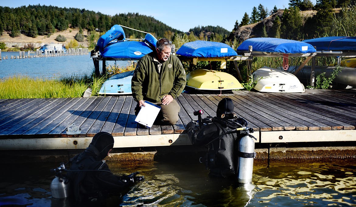 Montana Game Warden Jon Obst speaks with divers as they take part in a rapid response training on Thursday, Sept. 13, in Somers. (Brenda Ahearn/Daily Inter Lake)