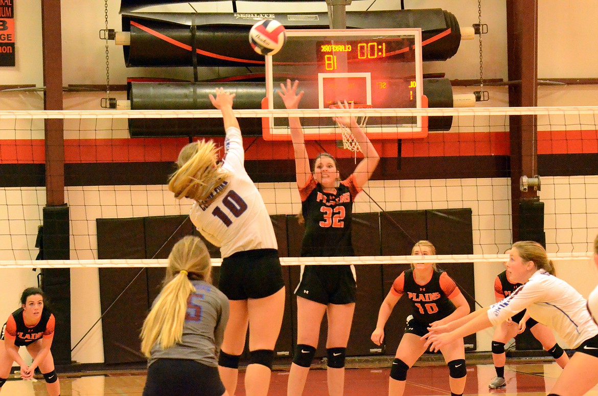 Trotter Kylee Altmiller attempts to block the ball on an attack by Mountain Cat Margaret Parkin during Plains&#146; match against Clark Fork. (Erin Jusseaume/ Clark Fork Valley Press)