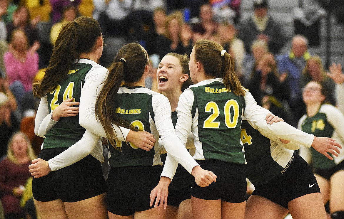 The Lady Dogs celebrate during a match with Libby last Thursday at Whitefish High School.