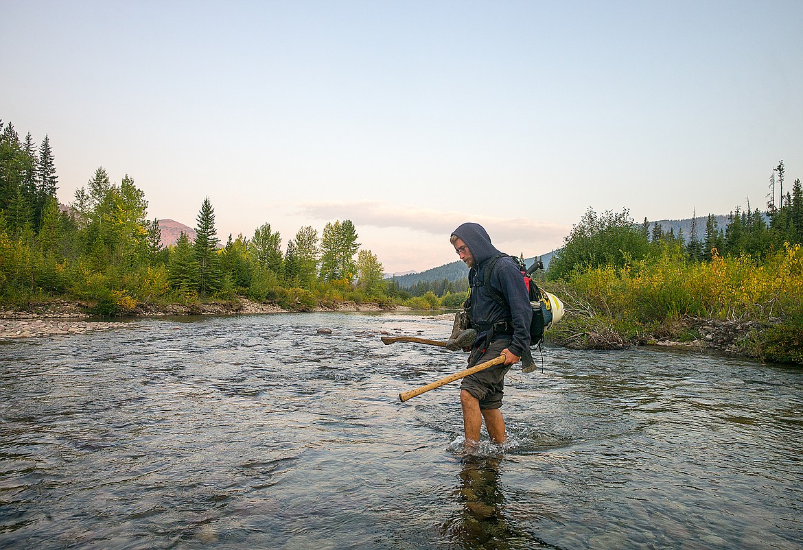 All in day&#146;s a work &#151; Forest Service trail crewman Cliff Hollingsworth crosses the Middle Fork of the Flathead near Schaefer Meadows.