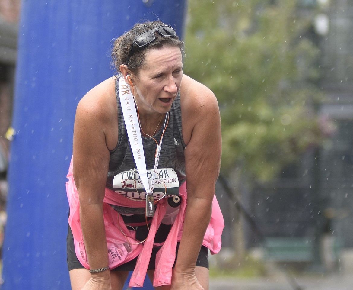 Kim Schussler catches her breath after finishing the Two Bear Half Marathon on Sunday.