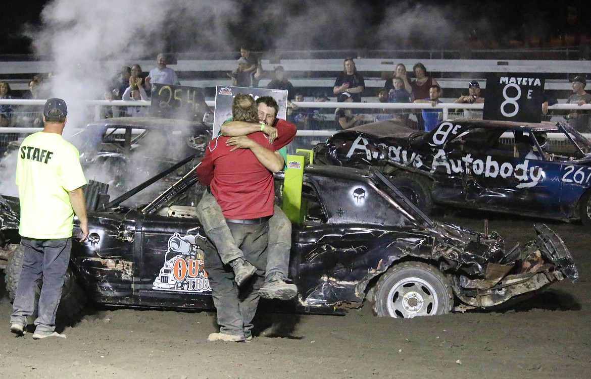 Photos by MANDI BATEMAN
Winner Kyle Wiebe hugs friend and third-place winner Derek Fedechko after Saturday night&#146;s Smash &amp; Bash demolition derby at the Boundary County Fairgrounds.