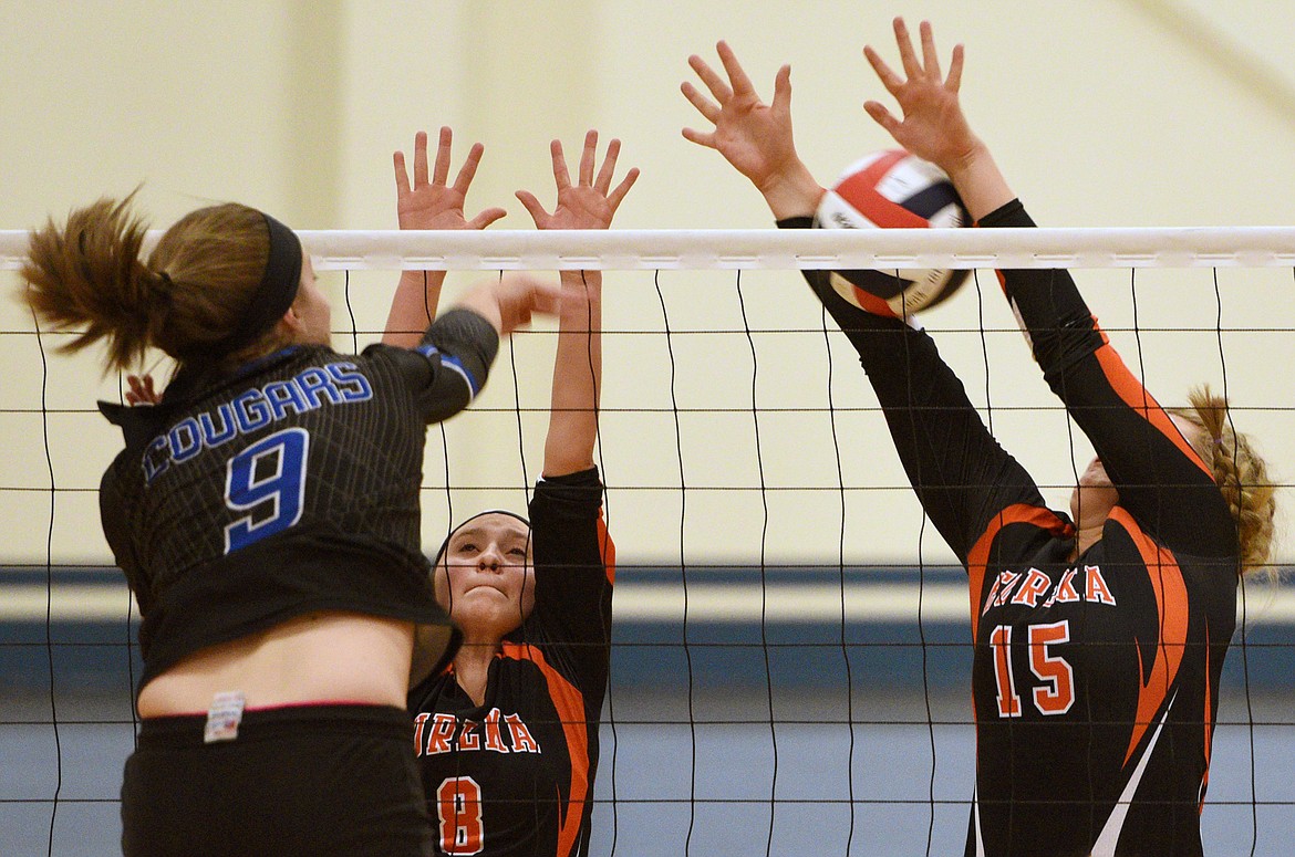 Eureka&#146;s Alyssa Utter (8) and Maggie Graves (15) look for a block at the net as Stillwater Christian&#146;s Helen Hashley (9) goes for a kill at Stillwater Christian School on Tuesday. (Casey Kreider/Daily Inter Lake)