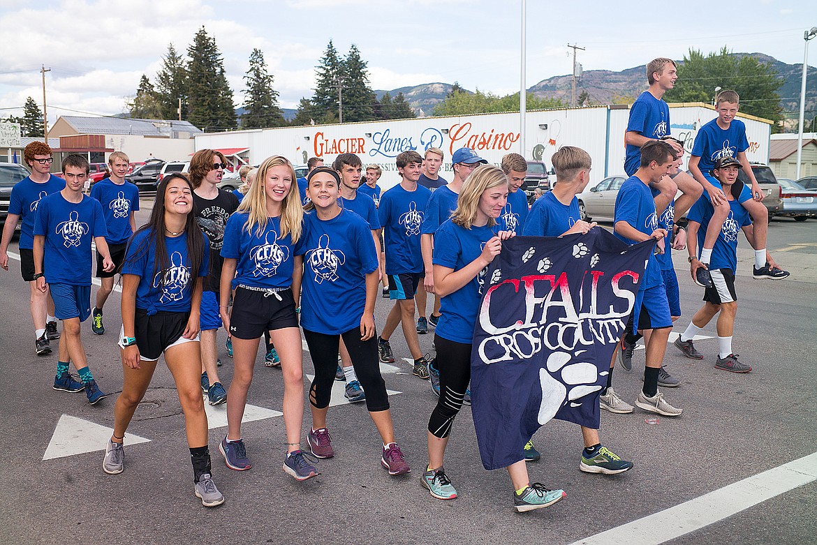 The cross country team walks in the parade.