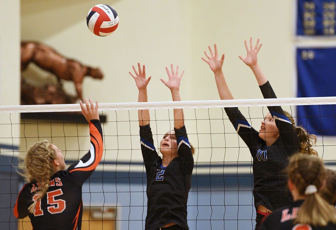 Eureka&#146;s Maggie Graves (15) goes up for a spike as Stillwater Christian&#146;s Ramey Metzger (2) and Abigail Hudson (10) go up for a block at Stillwater Christian School on Tuesday. (Casey Kreider/Daily Inter Lake)