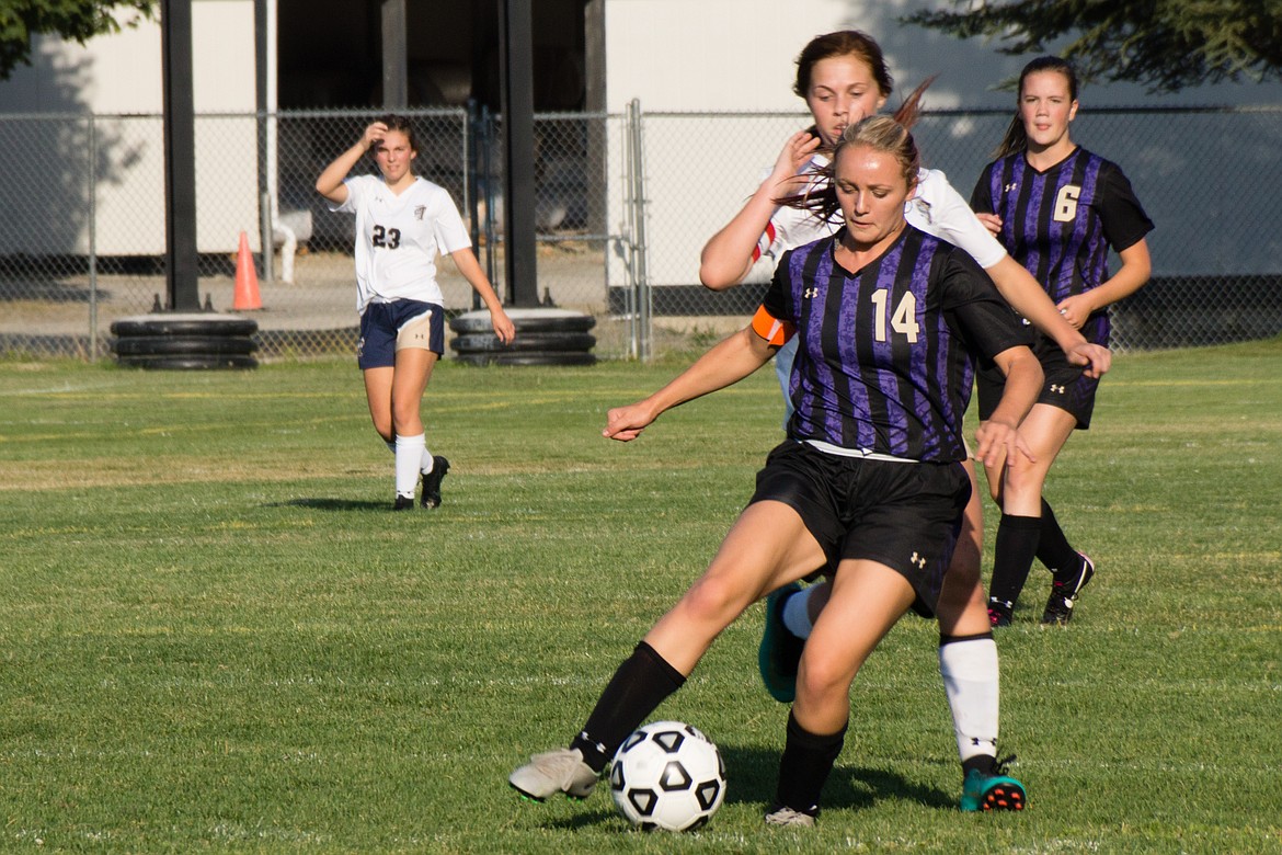 Taeya Sheppard dribbles through Timberlake defenders during the Wildcats&#146; match against Timberlake. 

Photo by Jeff Green