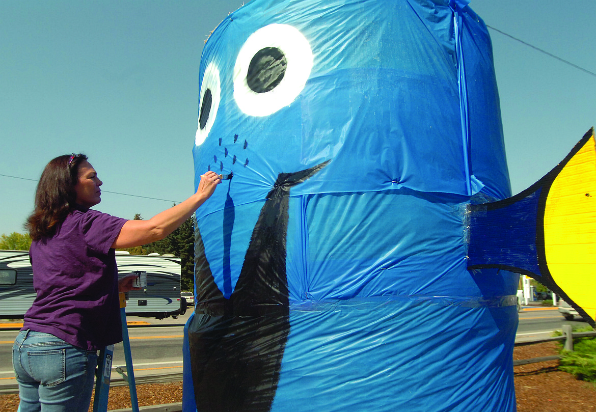 SAFE Harbor Executive Director DeeAnn Richardson puts the finishing touches on their display for the Harvest Fest Trail of Bales. (Joe Sova photos/Lake County Leader)