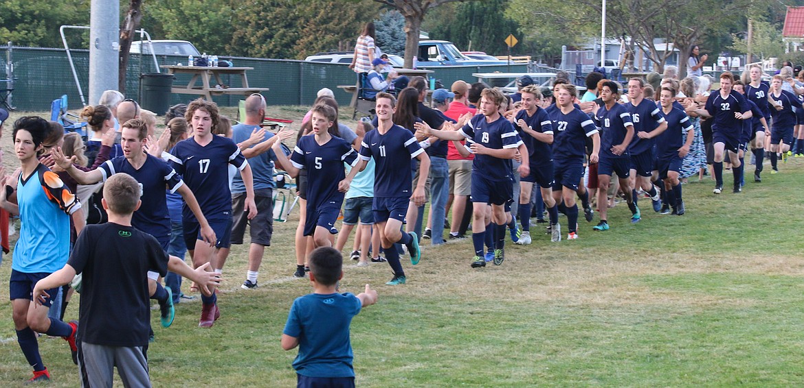 Photo by MANDI BATEMAN
Fans line up to congratulate the Boy&#146;s Soccer Team.