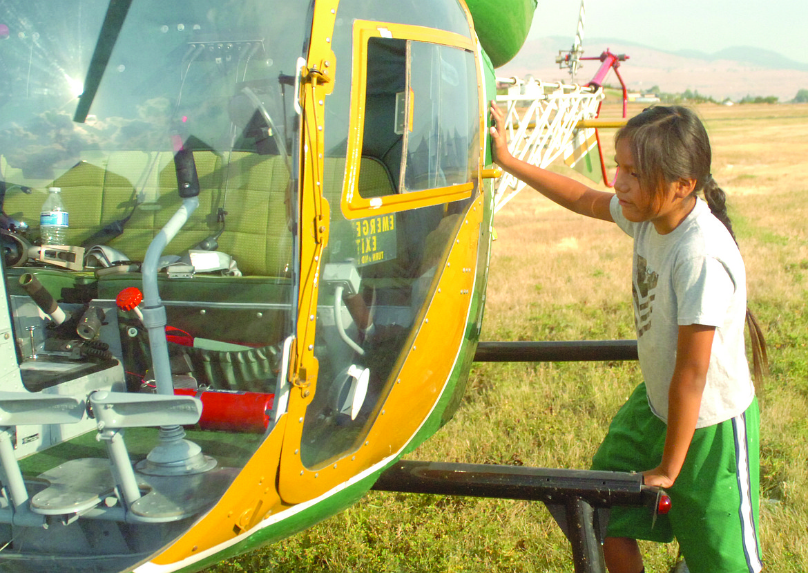 Patrick Villegas of Polson takes a close look at a helcopter that landed at the Polson Airport for the Sept. 8 fly-in. (Joe Sova/Lake County Leader)