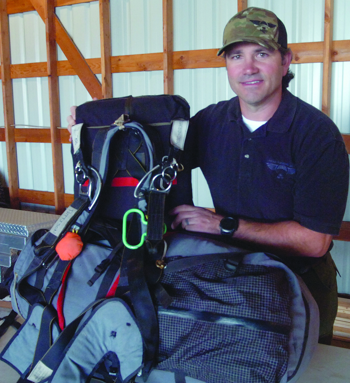 Andrew Pattison of Missoula Smoke Jumpers was on hand during last Saturday&#146;s Polson Fly-in to give a demonstration. He shows the heavy backpack that&#146;s strapped to his back when he jumps out of a plan en route to a wildfire.