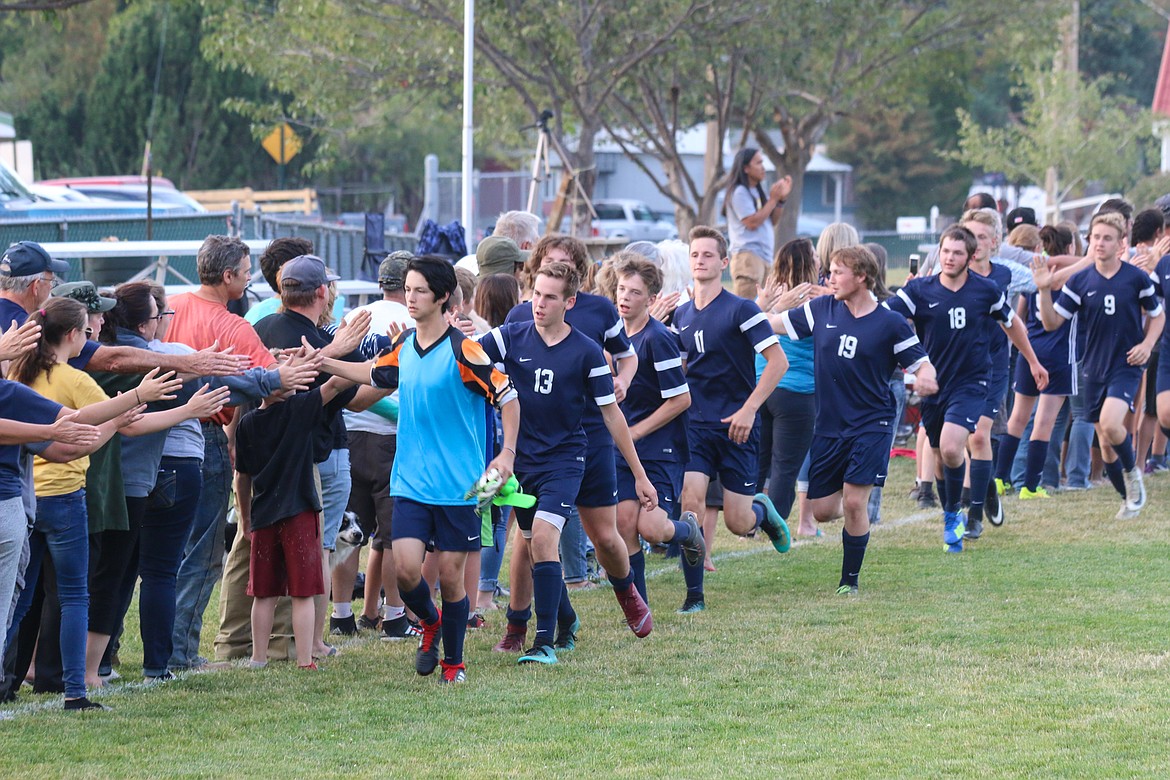 Photo by MANDI BATEMAN
The boys all give high fives to the loyal fans after the game.